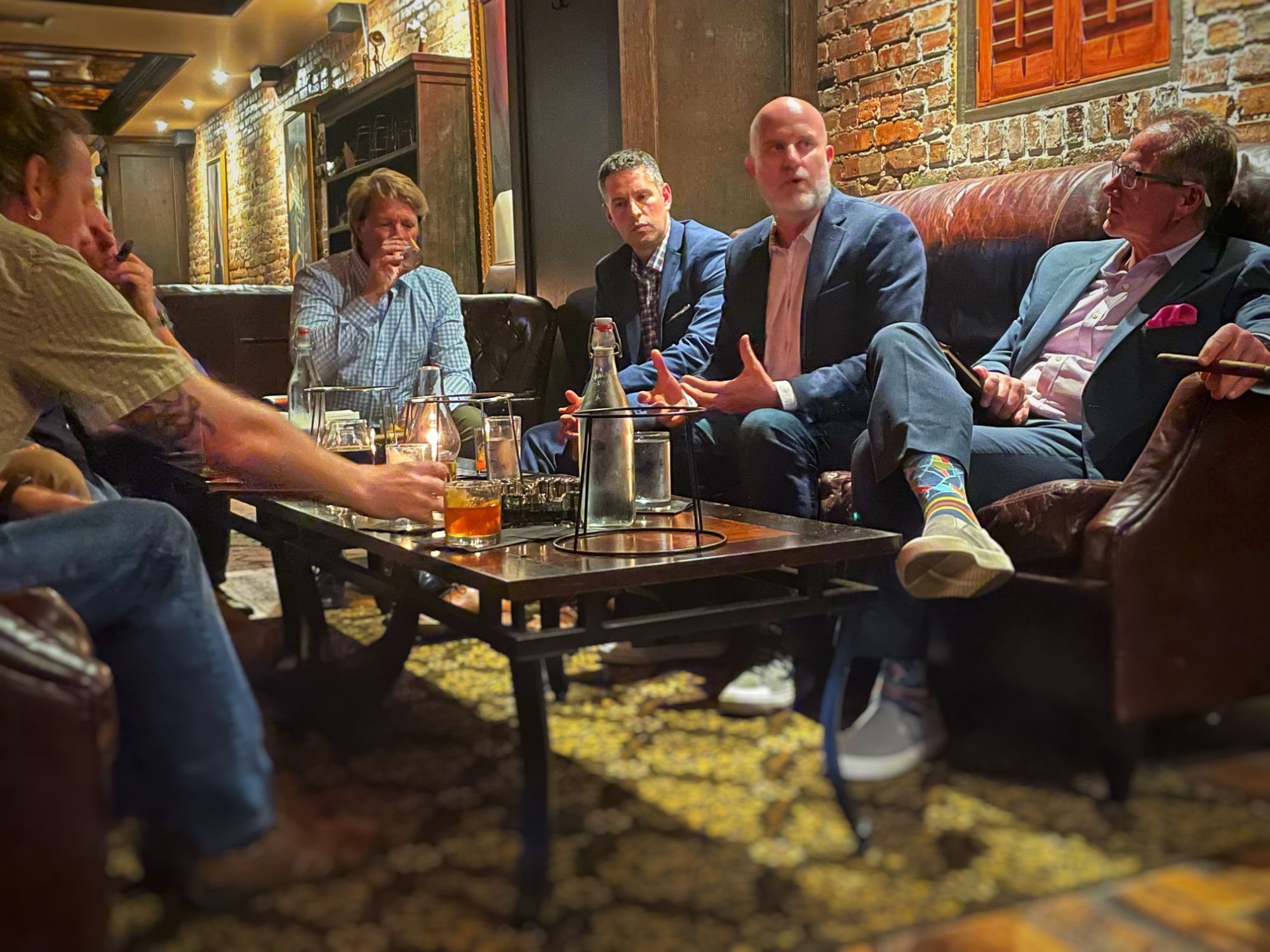 Angus Nelson in conversation with a group of executives