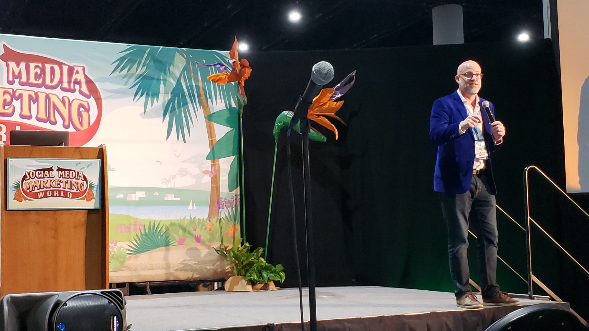 Angus Nelson speaking on stage