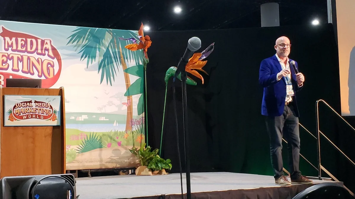 Angus Nelson speaking on stage