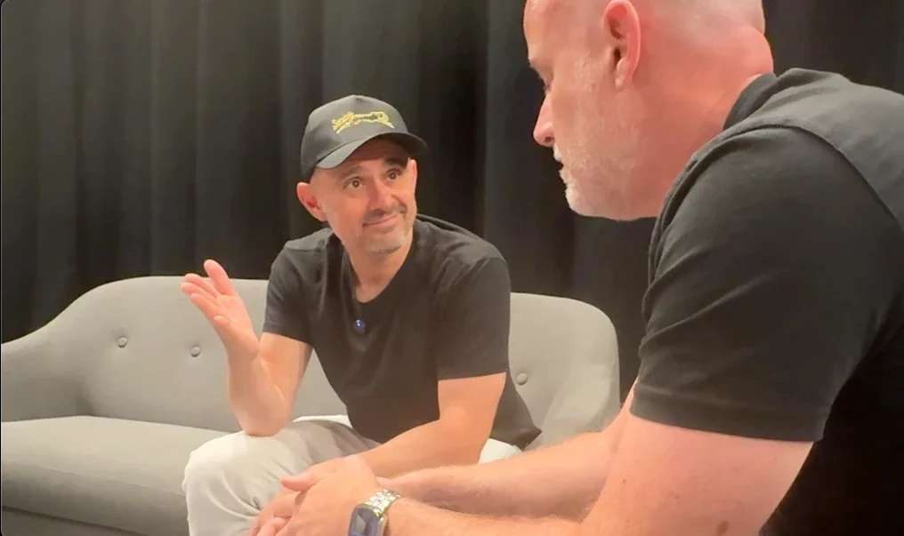 Angus Nelson in conversation with Gary Vaynerchuk, who looks toward him with a slight smile and a raised hand